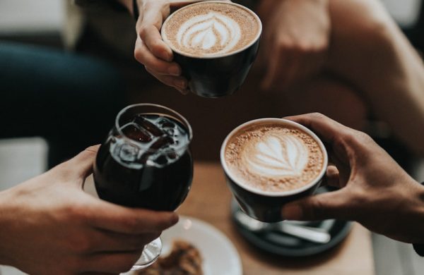 three person holding mug and glass with beverage inside